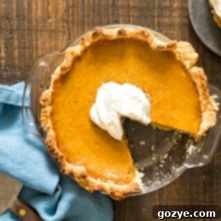 6 inch Pumpkin Pie in glass dish with slice missing