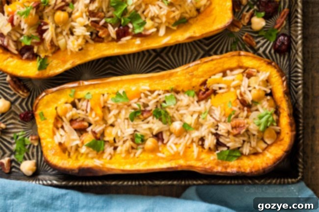 Savory Stuffed Butternut Squash 6 Close-up of a single stuffed butternut squash half on a baking sheet, showcasing the textured filling.