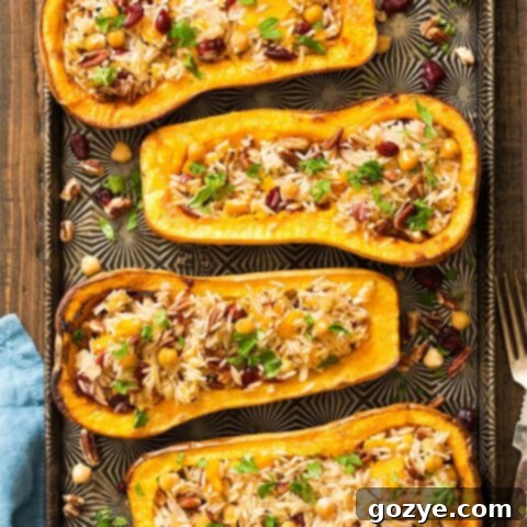 Savory Stuffed Butternut Squash 8 Four beautifully stuffed butternut squash halves on a baking sheet, golden and ready to serve.