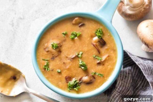 Blue bowl filled with brown mushroom gravy, ready for serving.