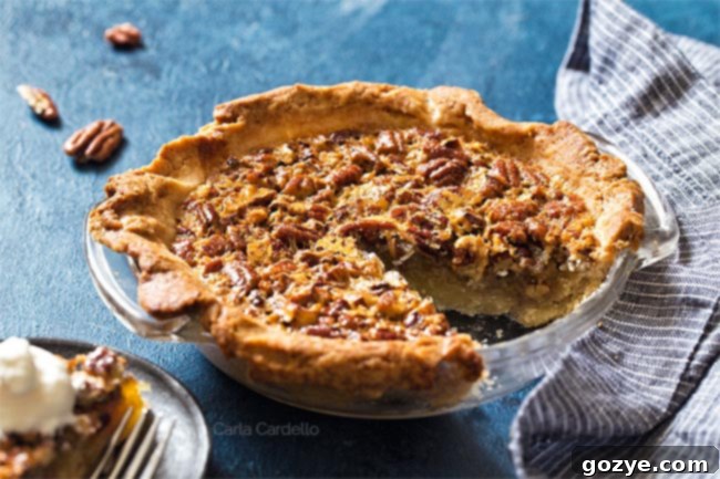 Pecan Pie with a slice missing in a glass pie plate