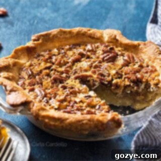 Pecan Pie with a slice missing in a glass pie plate
