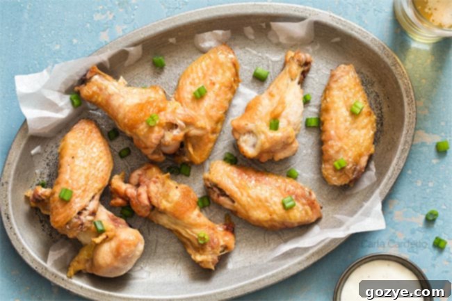 crispy wings on a silver plate with blue background