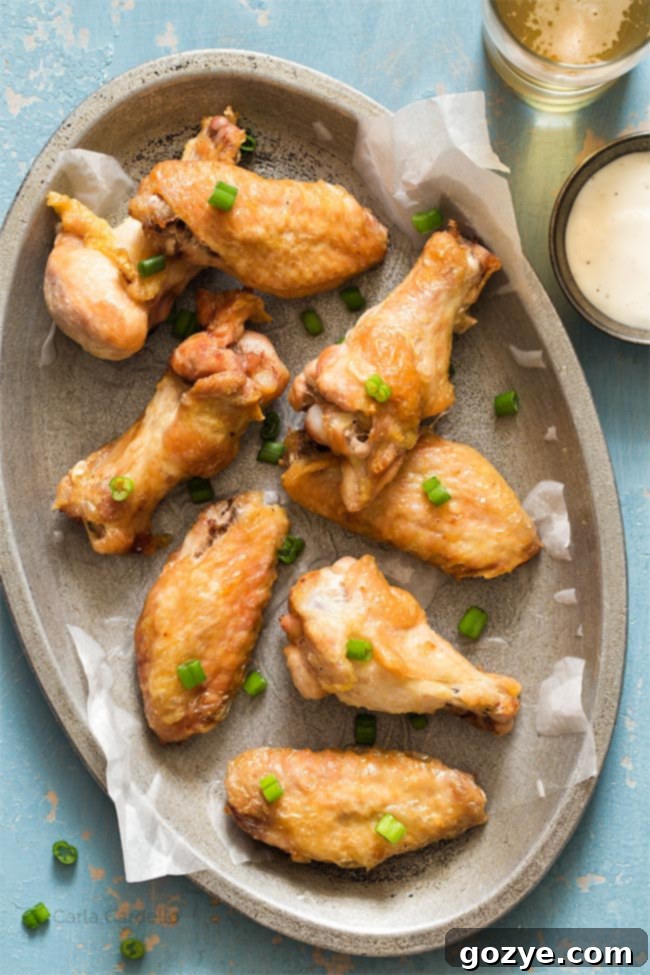 crispy wings on a silver plate with blue background