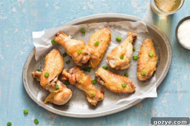 crispy wings on a silver plate with blue background
