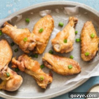 crispy wings on a silver plate with blue background
