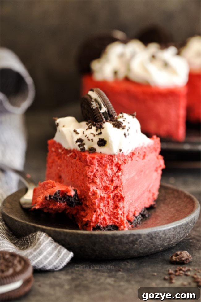 A perfectly baked slice of Red Velvet Oreo Cheesecake, showing its vibrant red filling, crisp Oreo crust, and creamy texture, ready to be enjoyed