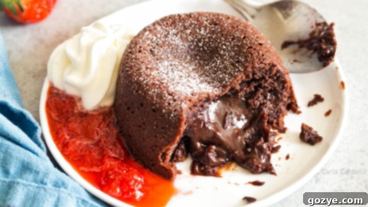 Mini Lava Cakes for two, dusted with powdered sugar and topped with whipped cream.