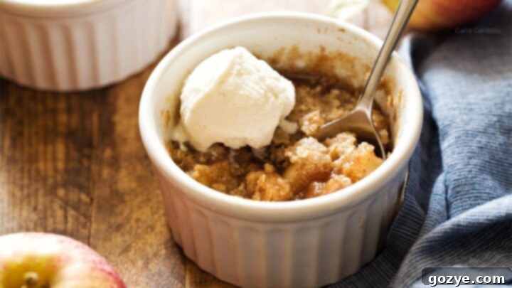 Warm and bubbly Apple Crisp For Two with a buttery streusel and vanilla ice cream.