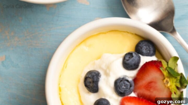 Air Fryer Cheesecake for two in ramekins, topped with whipped cream and berries.