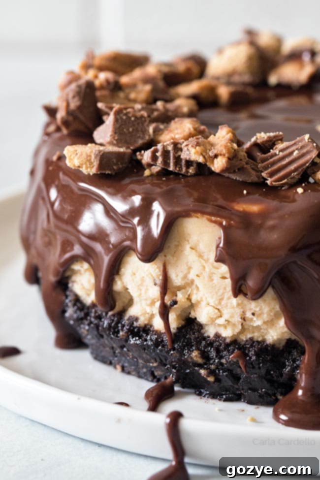 Rich chocolate ganache being generously poured over a creamy peanut butter cheesecake