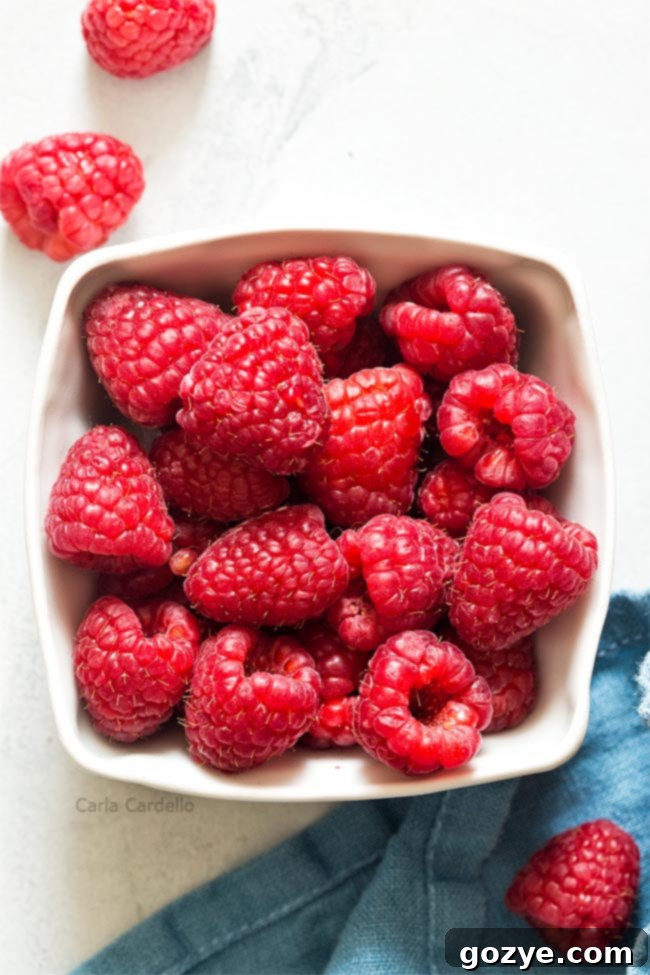 Basket of fresh, vibrant red raspberries
