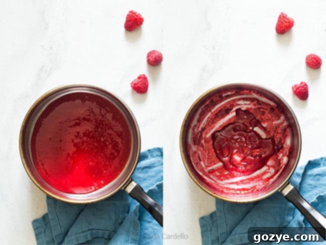 Cooking down raspberry puree in a small saucepan on a stovetop