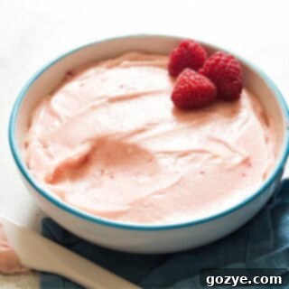 Raspberry cream cheese frosting in white bowl