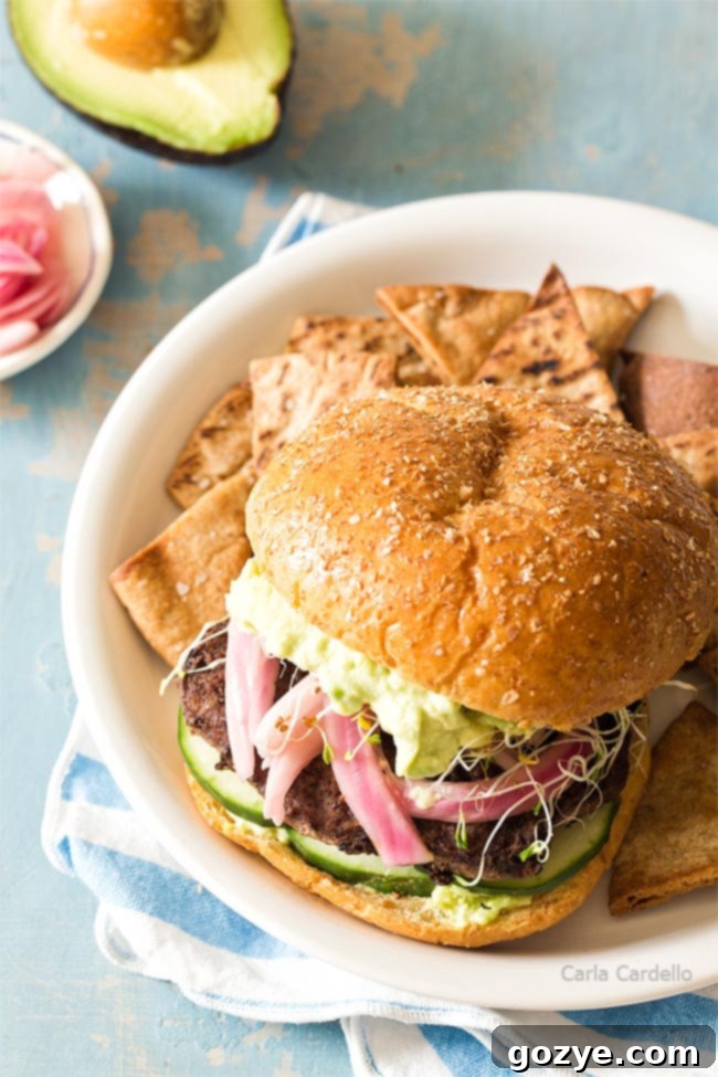 Angle of avocado burger on white plate