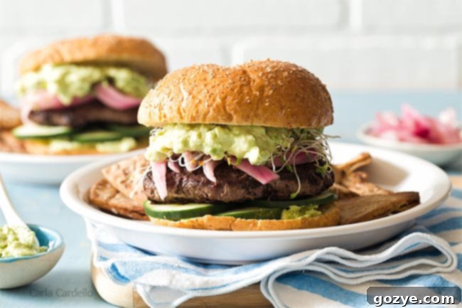 Avocado Burger on white plate with blue napkin