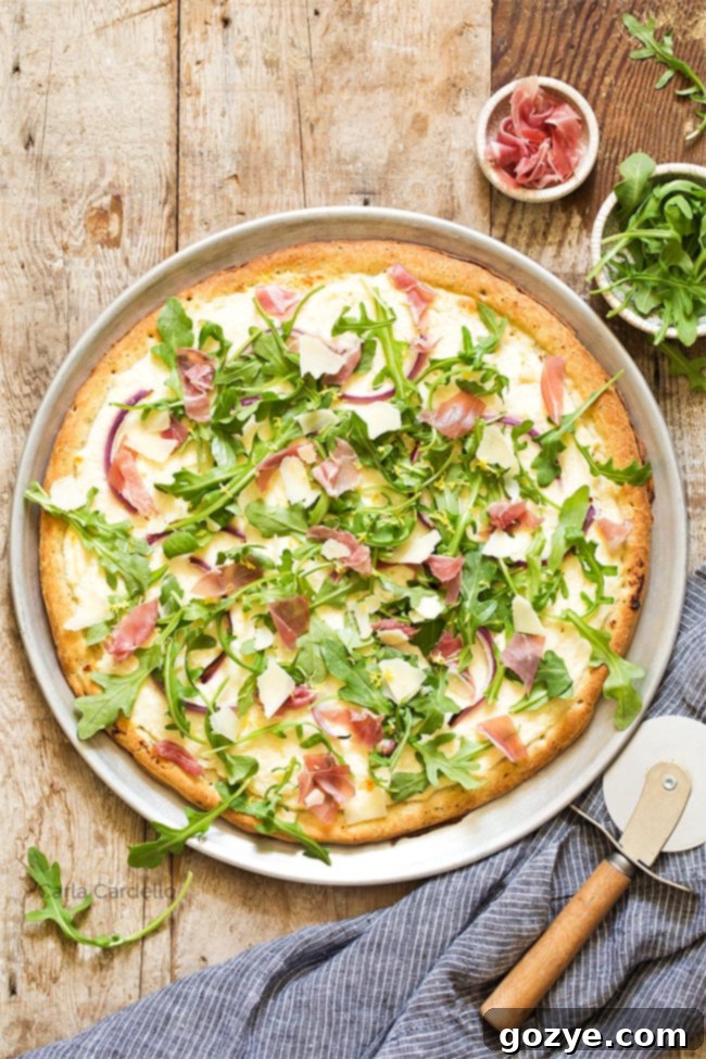 Prosciutto and Arugula Pizza 2 Prosciutto Arugula Pizza on a pizza pan with pizza cutter