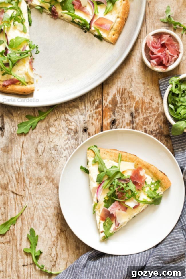 Prosciutto and Arugula Pizza 6 Slice of prosciutto pizza on a white plate