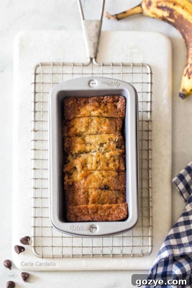 Petite Banana Bread Delights 3 Two mini banana bread loaves, one whole and one sliced, in a mini loaf pan