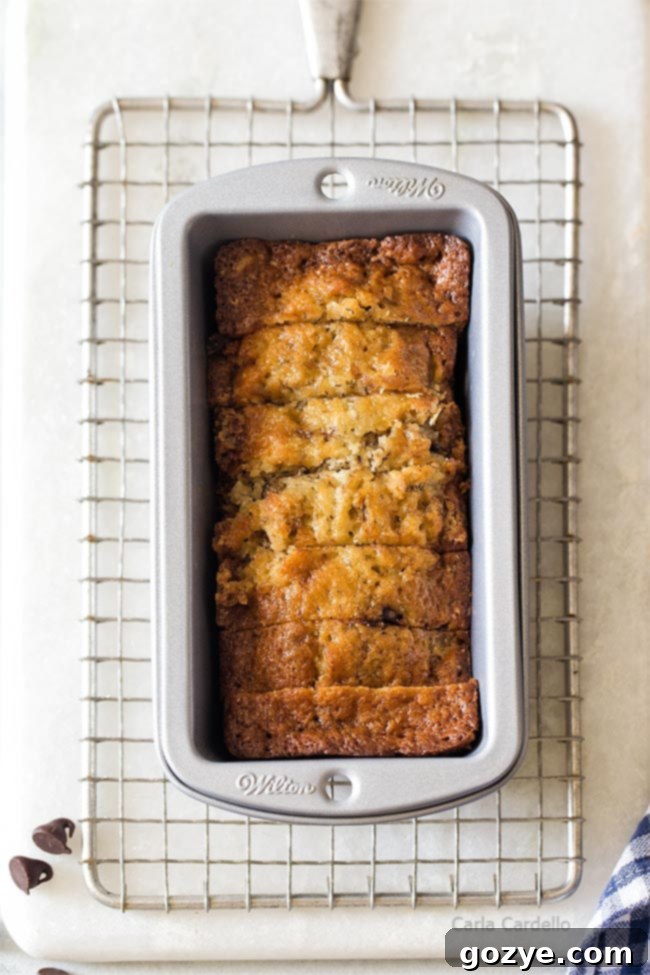 Petite Banana Bread Delights 8 A sliced mini banana bread loaf inside its mini pan, revealing its texture