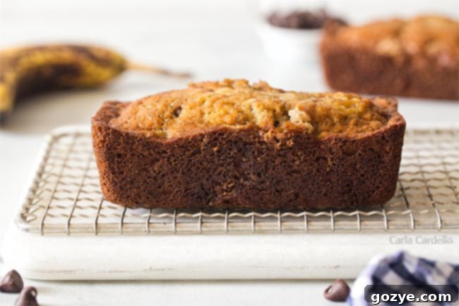 Petite Banana Bread Delights 9 A baked mini banana bread loaf on a rustic cutting board, ready to be sliced