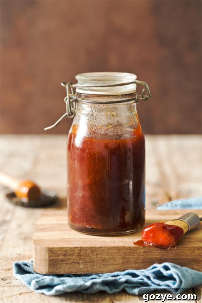 Jar of honey bbq sauce on a cutting board