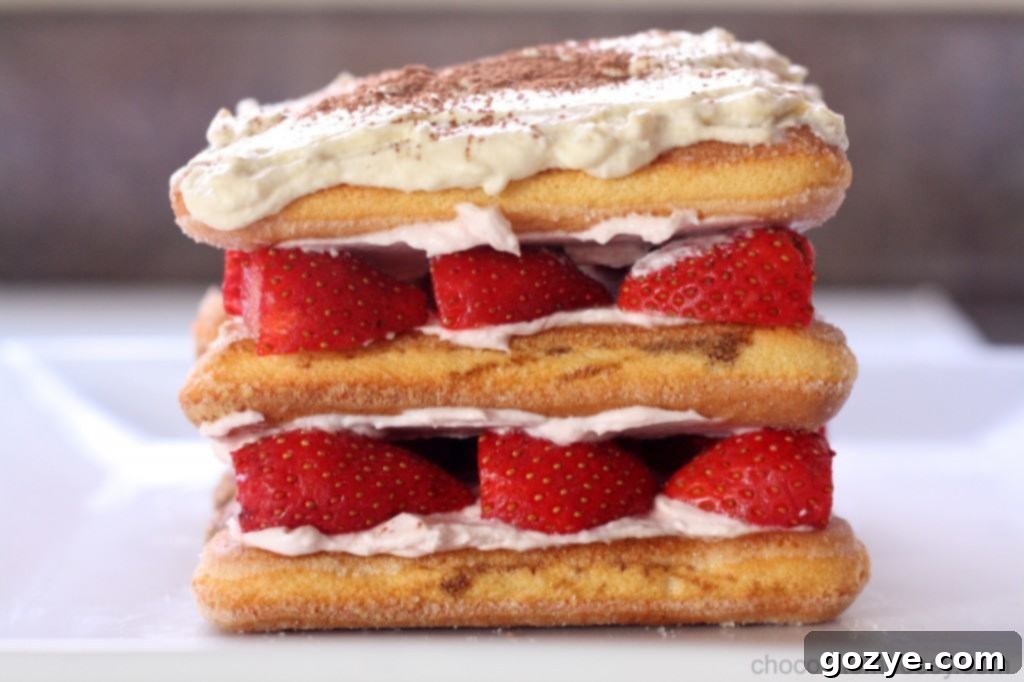 Sliced Strawberry Tiramisu on a plate, showing the layers and fresh fruit