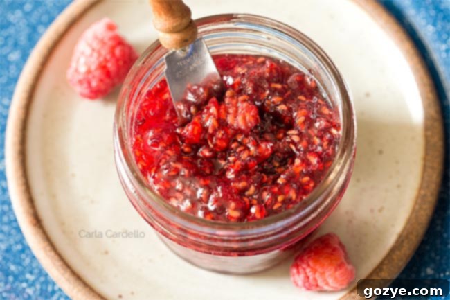 Raspberry Jam in mini jar with knife sticking out