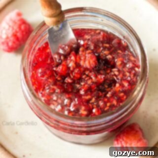 Raspberry Jam in mini jar with knife sticking out