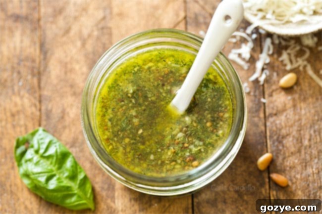 Small jar of homemade basil pesto with a white spoon