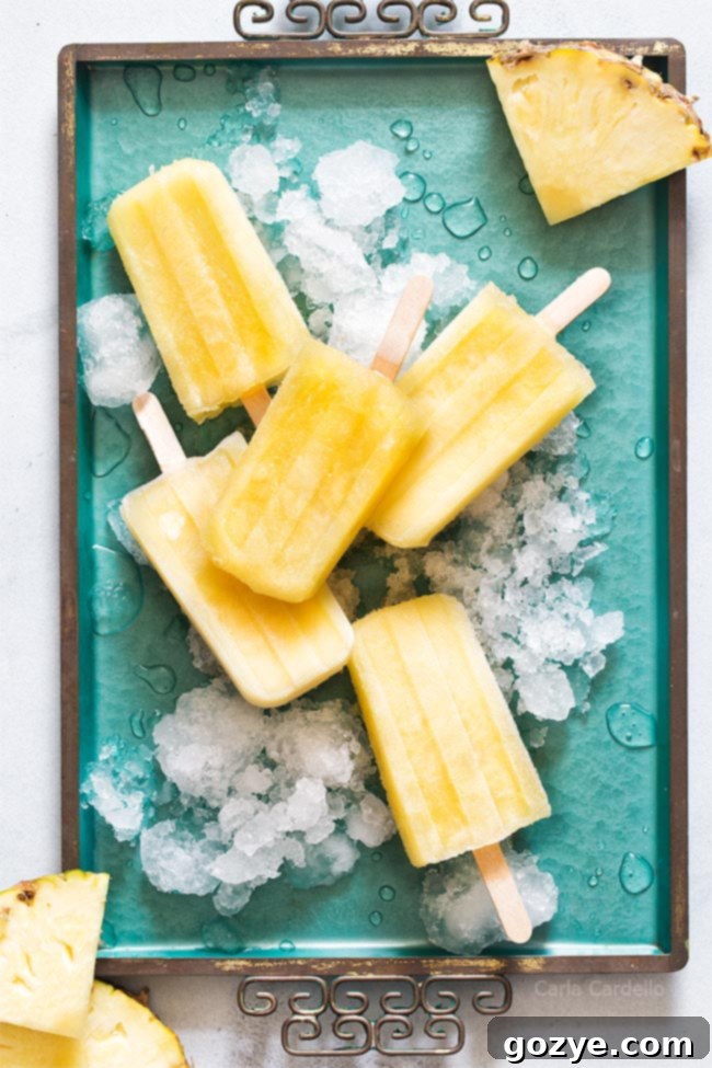 Pineapple popsicles on a teal tray