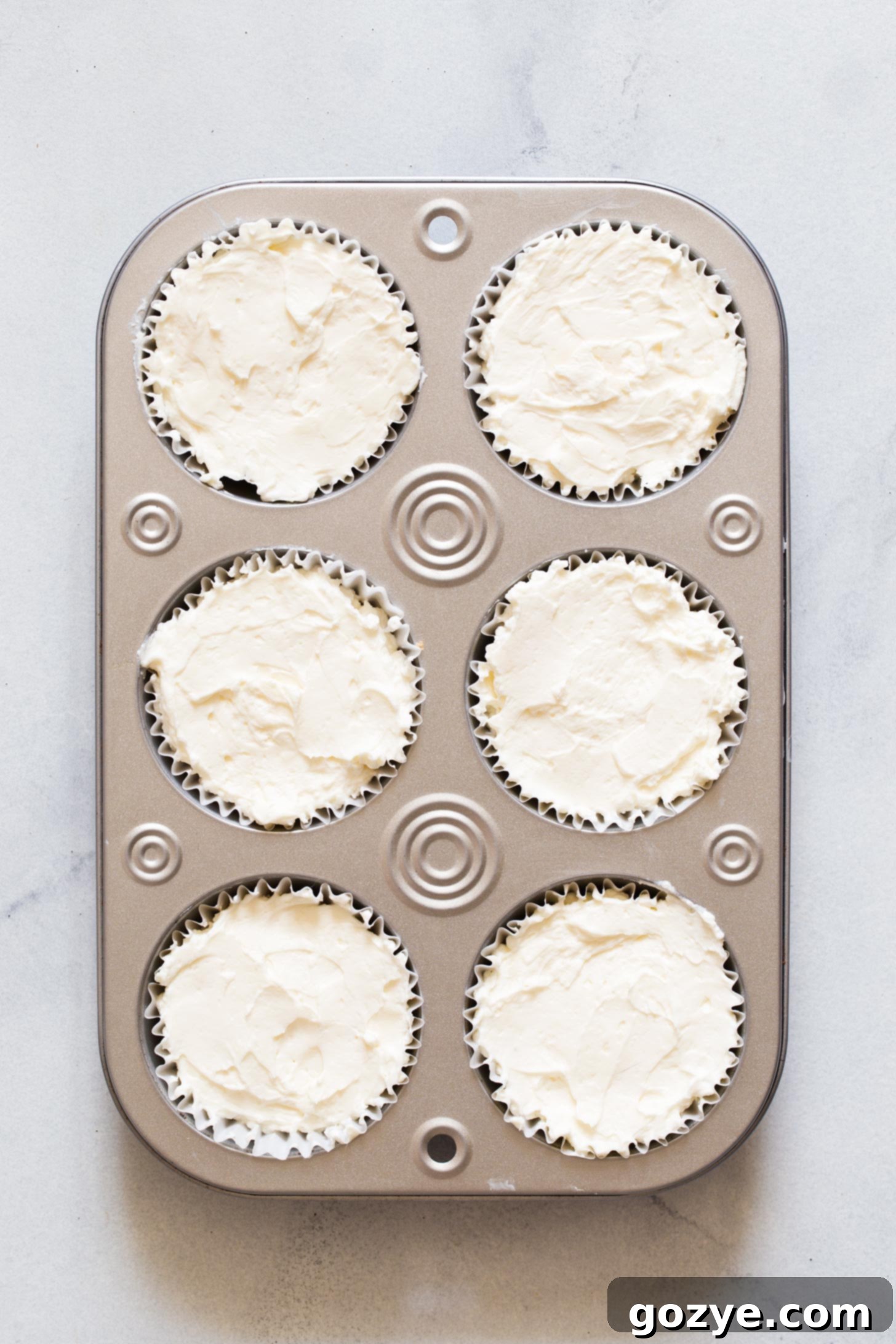 Quick No-Bake Cheesecake Bites 10 Finished No Bake Mini Cheesecakes, perfectly set in a muffin pan, ready to be served