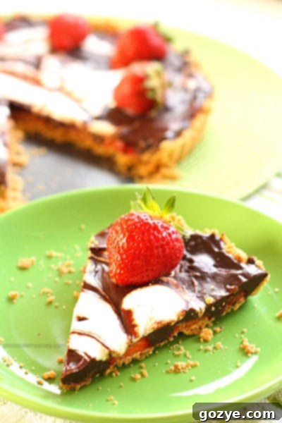 Delicious Strawberry S'mores Tart with fresh berries on a wooden board