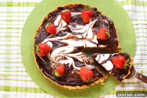 Close-up of a slice of Strawberry S'mores Tart showing layers of crust, chocolate, strawberries, and marshmallow
