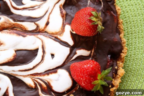 Ingredients for Strawberry S'mores Tart laid out, including fresh strawberries and chocolate