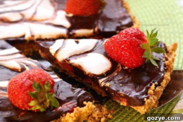 Strawberry S'mores Tart crust being pressed into a tart pan with removable bottom