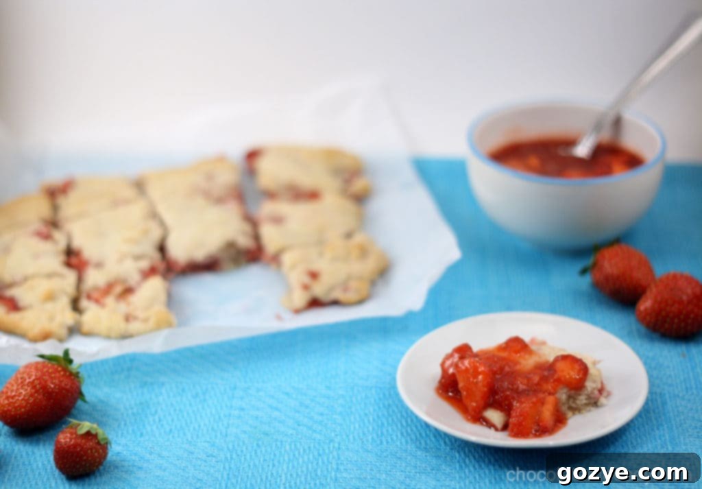 Freshly baked Strawberry Cream Biscuits with vibrant strawberry slices visible throughout
