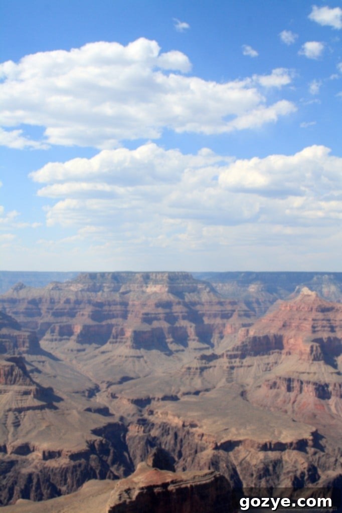 A serene vertical shot of the Grand Canyon, with a focus on the distant horizon.