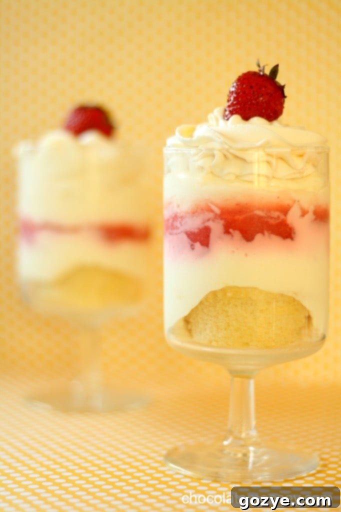 Close-up of Strawberry Cheesecake Parfait showing distinct layers of cheesecake, strawberry curd, and a crumbly base