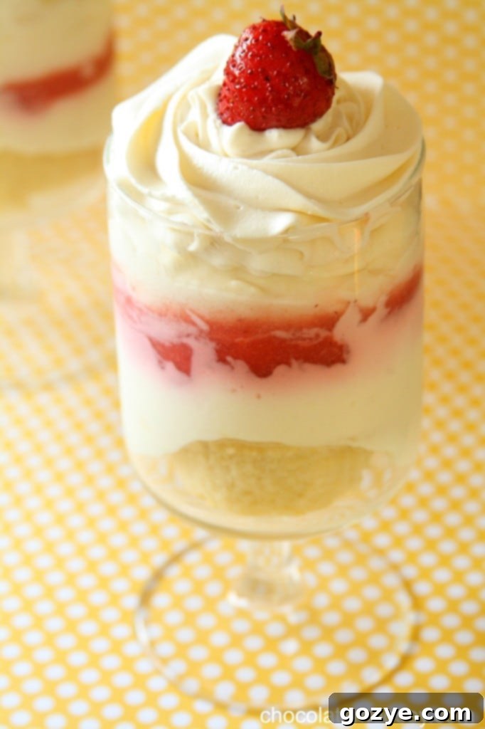 Preparing Strawberry Cheesecake Parfaits in glasses, showing the first layer of cake pieces