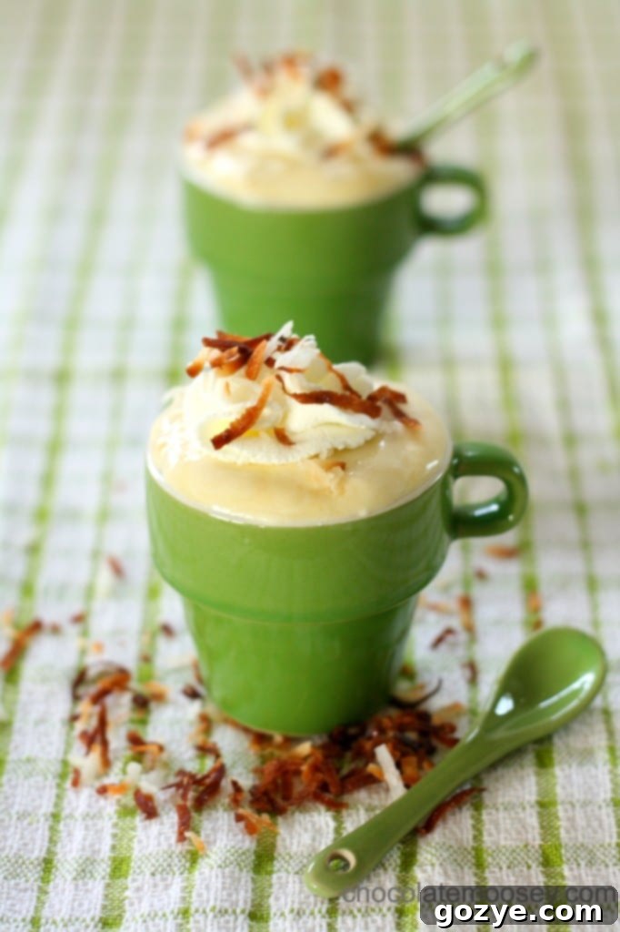 Two servings of Coconut Cream Pudding with whipped cream and toasted coconut