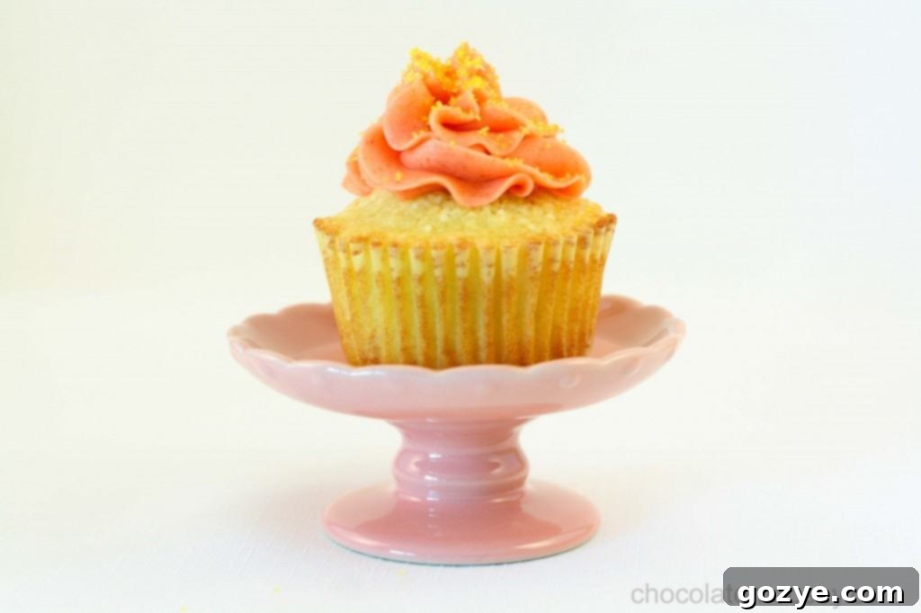 A beautifully frosted Strawberry Lemonade Cupcake ready to be served