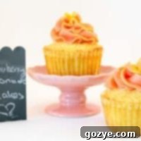 Strawberry Lemonade Cupcakes with a swirl of frosting and fresh strawberries