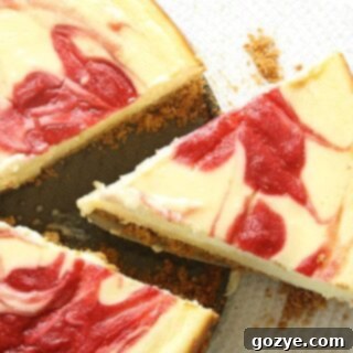 A slice of strawberry cheesecake being removed with a cake cutter, ready to be served.