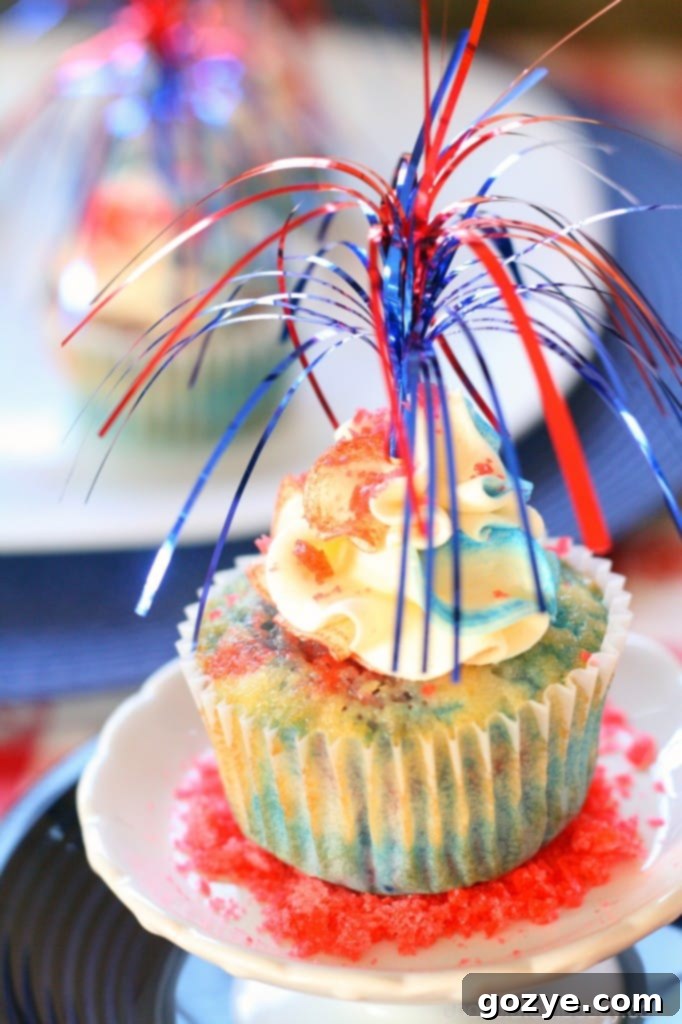 A tray of colorful Red, White, and Blue Firecracker Cupcakes ready for celebration.