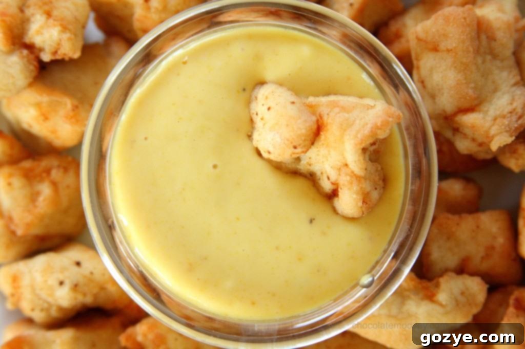 Cooked Copycat Chick-Fil-A Nuggets served on a plate with a bowl of Honey Mustard Dipping Sauce