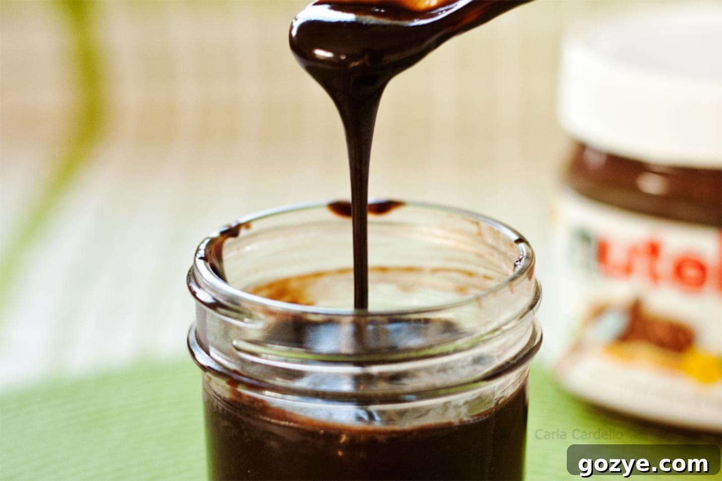 Nutella Sauce being smoothly poured back into its jar, highlighting its luxurious texture