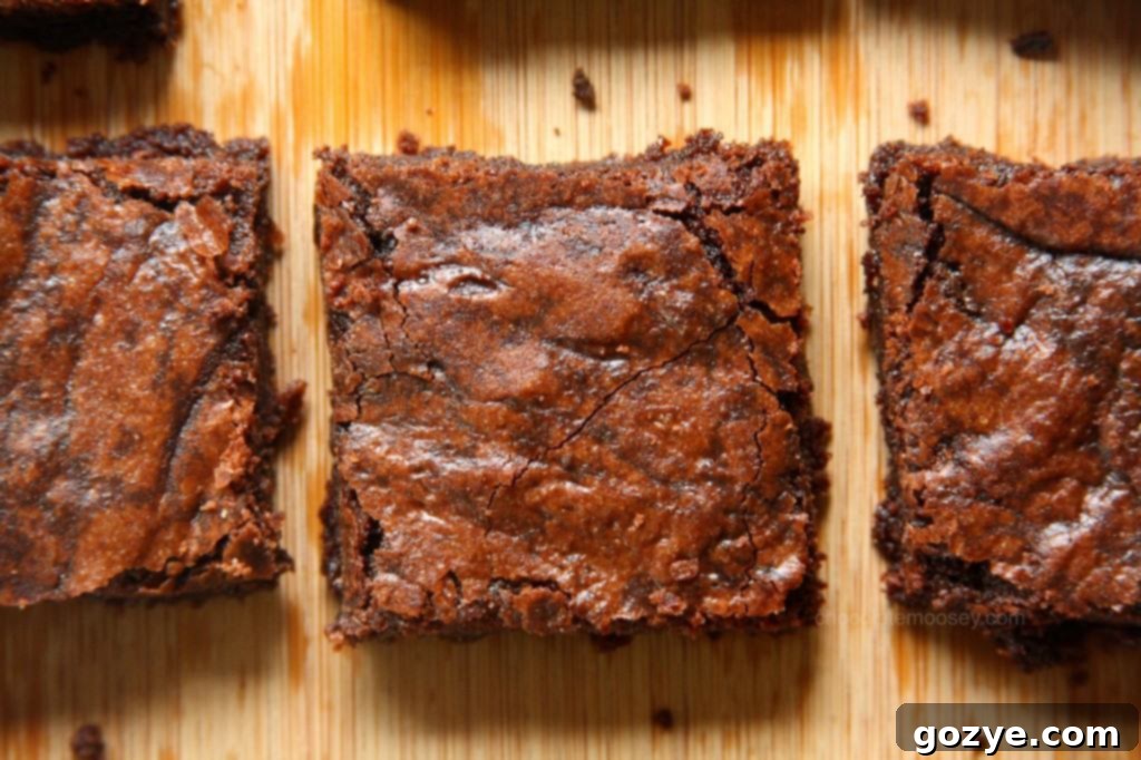 Overhead shot of one-pot fudgy raspberry cocoa brownies in a pan, cut into perfect squares