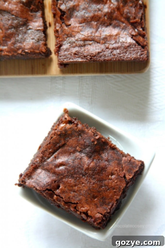 A close-up of a delicious one-pot fudgy raspberry cocoa brownie, showing its moist texture