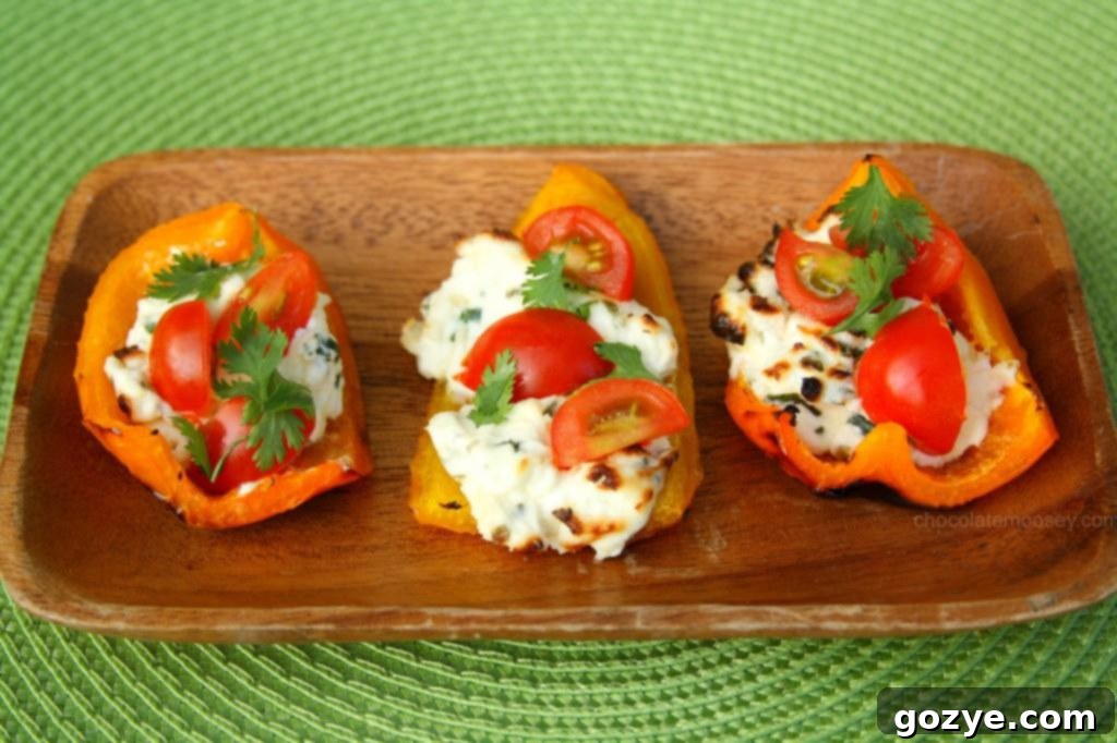 Herbed Cream Cheese Grilled Bell Pepper Boats Grilled bell pepper boats being assembled with herbed cream cheese filling